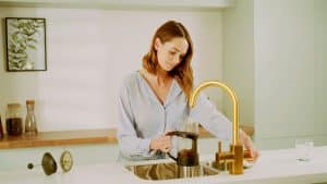 woman-making-tea-boiling-tap
